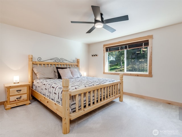 bedroom with baseboards, a ceiling fan, and light carpet