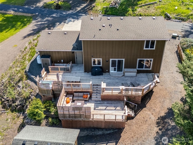 rear view of house with roof with shingles, central air condition unit, an outdoor hangout area, and a wooden deck