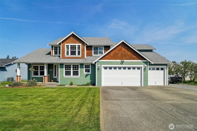craftsman-style home featuring concrete driveway, an attached garage, a front lawn, and a shingled roof