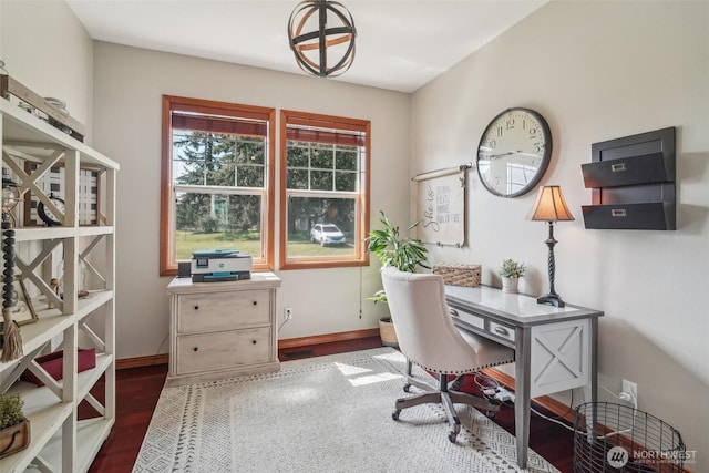 office space with wood finished floors and baseboards