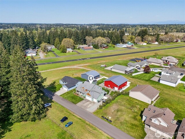 aerial perspective of suburban area featuring a forest