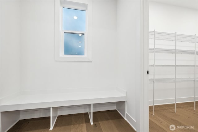 mudroom featuring wood finished floors and baseboards