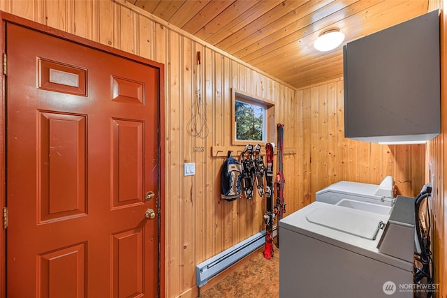 18016 Glacier Rim Dr, Glacier, WA 98244 - washroom featuring washing machine and clothes dryer, laundry area, wood walls, wood ceiling, and a baseboard radiator