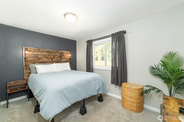 carpeted bedroom featuring baseboards