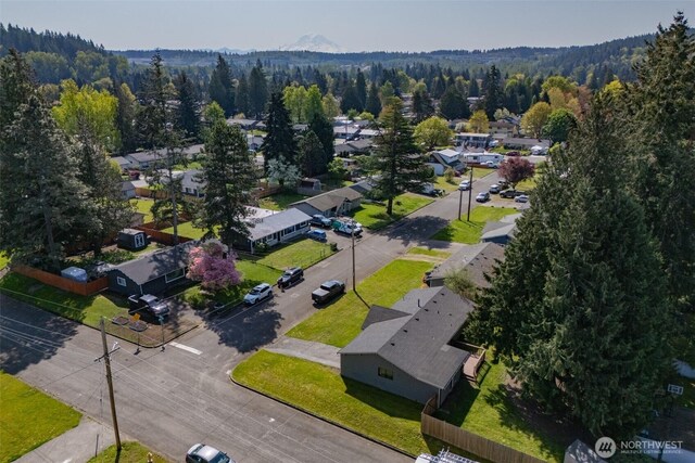 birds eye view of property featuring a residential view and a wooded view
