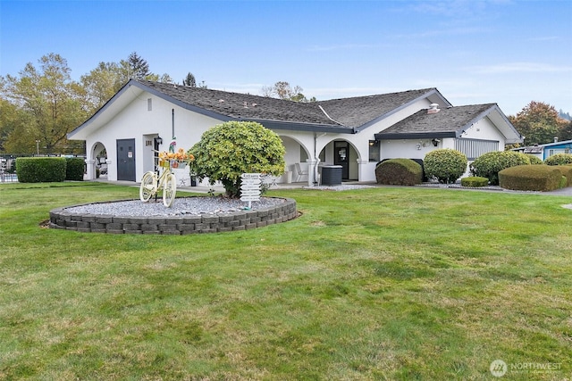 single story home featuring stucco siding, a front lawn, and central AC unit