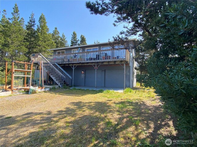 29008 K Ln, Ocean Park, WA 98640 - rear view of house with stairs, a wooden deck, and a garage