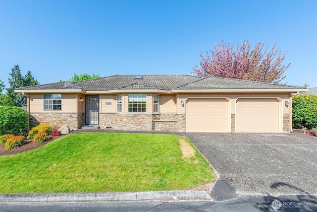 ranch-style home with a tile roof, driveway, stone siding, a front lawn, and an attached garage