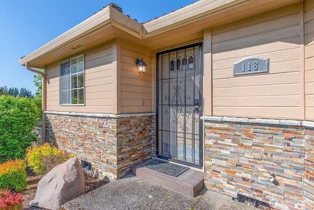 view of exterior entry with stone siding