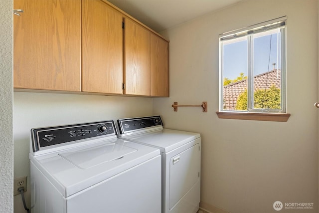 washroom featuring cabinet space and washing machine and dryer