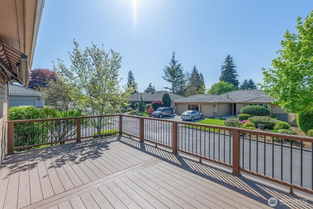 deck featuring a residential view and an attached garage