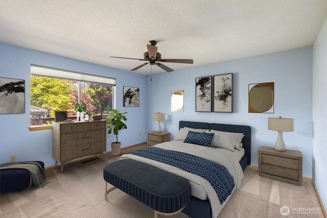 bedroom featuring baseboards, light carpet, and ceiling fan