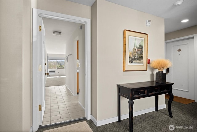 hall featuring carpet floors, recessed lighting, baseboards, and tile patterned floors