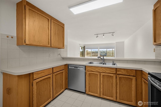 kitchen with light countertops, a sink, tasteful backsplash, and stainless steel appliances