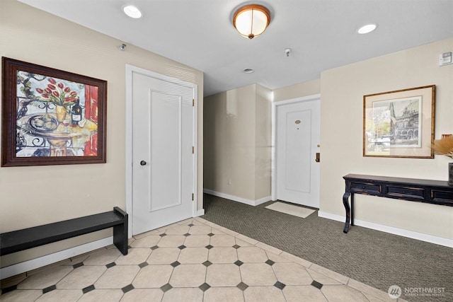foyer entrance with recessed lighting, baseboards, light carpet, and light floors