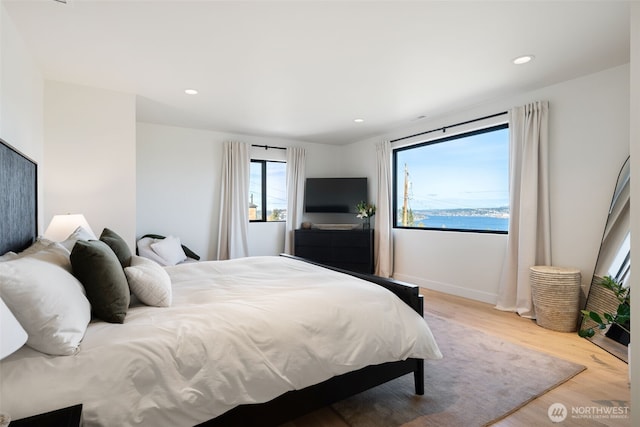 bedroom with baseboards, recessed lighting, and wood finished floors