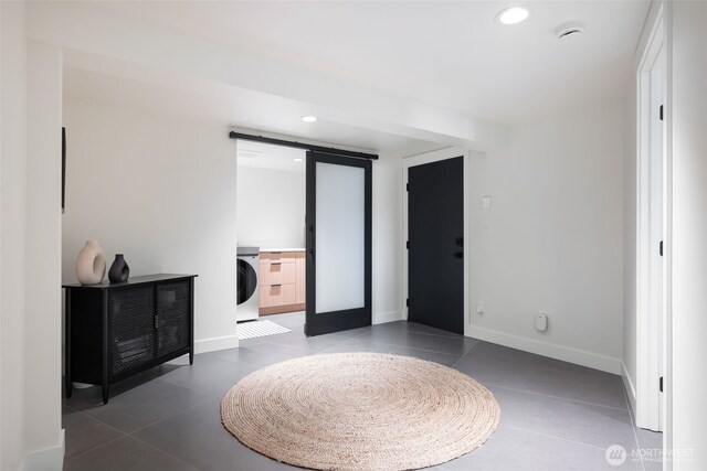 bedroom with washer / clothes dryer, a barn door, baseboards, recessed lighting, and tile patterned flooring