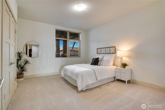 carpeted bedroom featuring baseboards