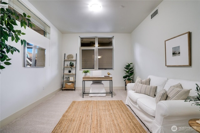 carpeted living room featuring visible vents and baseboards