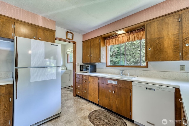 3828 Harbel Dr NE, Bremerton, WA 98310 - kitchen with washer / clothes dryer, light countertops, a sink, and white appliances