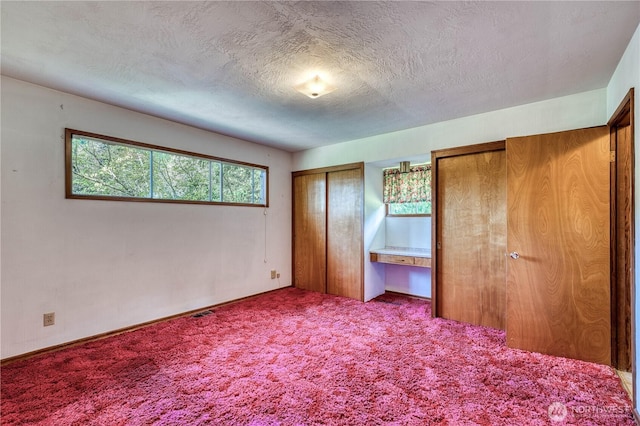 3828 Harbel Dr NE, Bremerton, WA 98310 - unfurnished bedroom featuring carpet flooring, a textured ceiling, and two closets