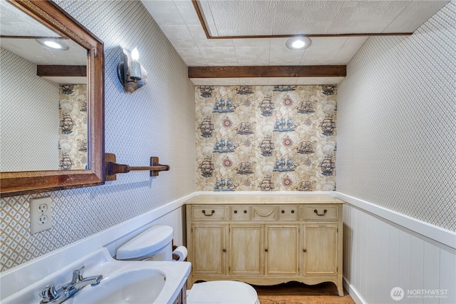 3828 Harbel Dr NE, Bremerton, WA 98310 - bathroom featuring toilet, a sink, wallpapered walls, and wood finished floors