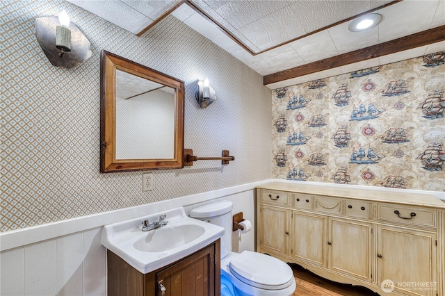 3828 Harbel Dr NE, Bremerton, WA 98310 - bathroom featuring vanity, toilet, wainscoting, wallpapered walls, and wood finished floors