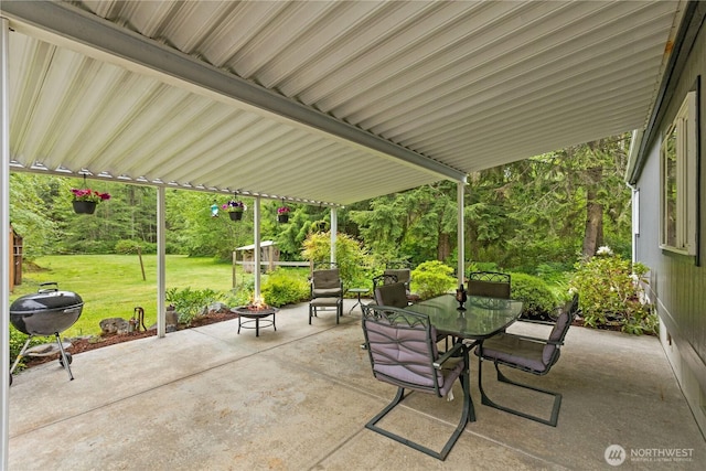 view of patio / terrace with grilling area, an outdoor fire pit, and outdoor dining space