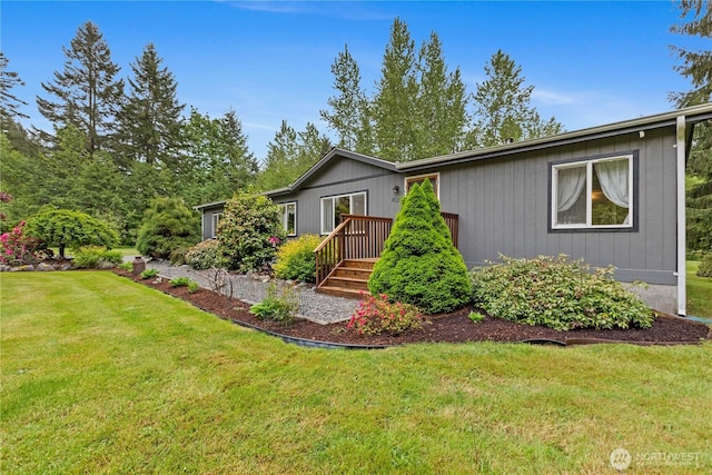 view of front facade with a front lawn and a wooden deck