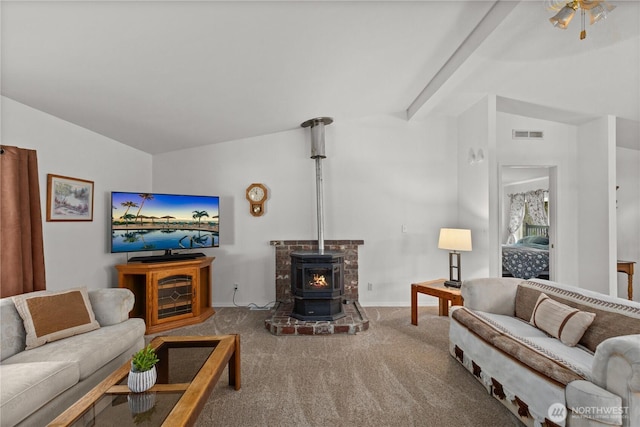 carpeted living area with baseboards and a wood stove