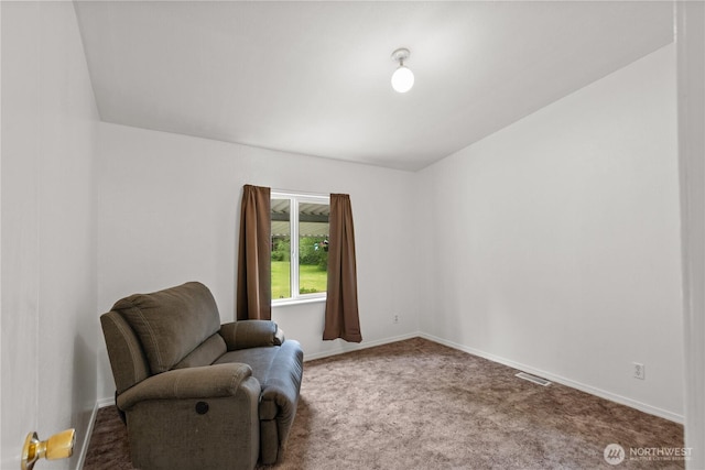 living area featuring carpet floors and baseboards