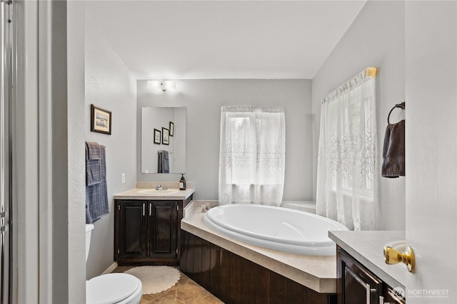 full bath with a bath, vanity, and toilet
