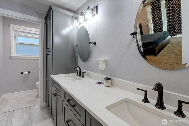4204 Arbordale Ave W, University Place, WA 98466 - full bathroom with toilet, double vanity, and baseboards