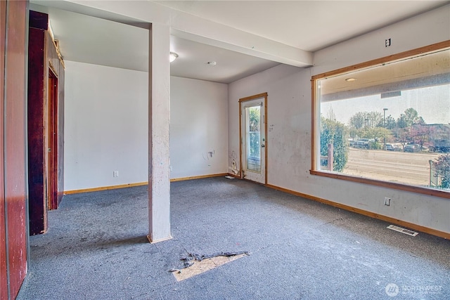 foyer with baseboards, visible vents, and carpet floors