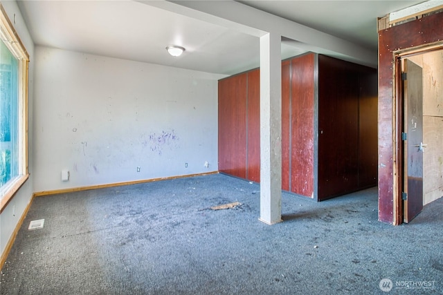interior space with carpet floors, baseboards, and visible vents