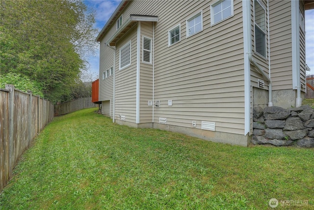 view of side of property featuring a yard and fence