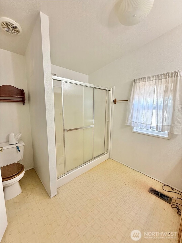 84 Weatherstone Rd, Omak, WA 98841 - bathroom featuring toilet, a shower stall, and tile patterned floors