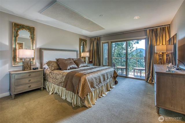 bedroom featuring access to exterior and light carpet