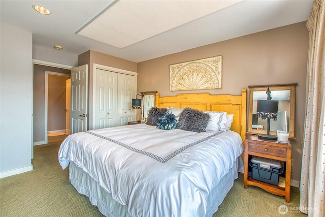 carpeted bedroom with baseboards and a closet