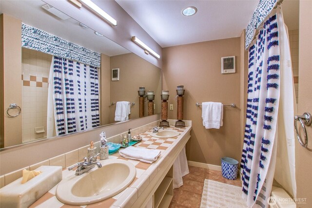 full bathroom with tile patterned floors, a shower with curtain, double vanity, baseboards, and recessed lighting