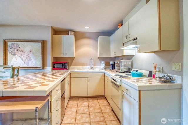 kitchen featuring white range with electric stovetop, tile counters, a sink, under cabinet range hood, and recessed lighting