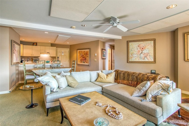 carpeted living area with baseboards, a ceiling fan, and recessed lighting