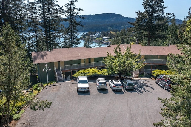 view of front of house featuring uncovered parking, stairs, and a mountain view