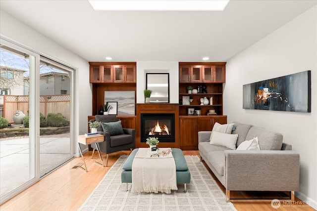 15510 NE 59th St, Redmond, WA 98052 - living area with recessed lighting, a glass covered fireplace, and light wood-type flooring