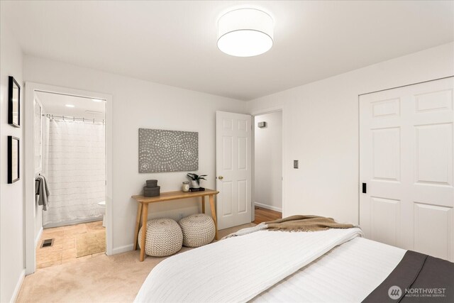 15510 NE 59th St, Redmond, WA 98052 - bedroom featuring a closet, connected bathroom, light colored carpet, baseboards, and visible vents