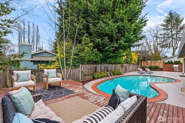 15510 NE 59th St, Redmond, WA 98052 - view of swimming pool featuring a wooden deck, a fenced backyard, a fenced in pool, and outdoor lounge area