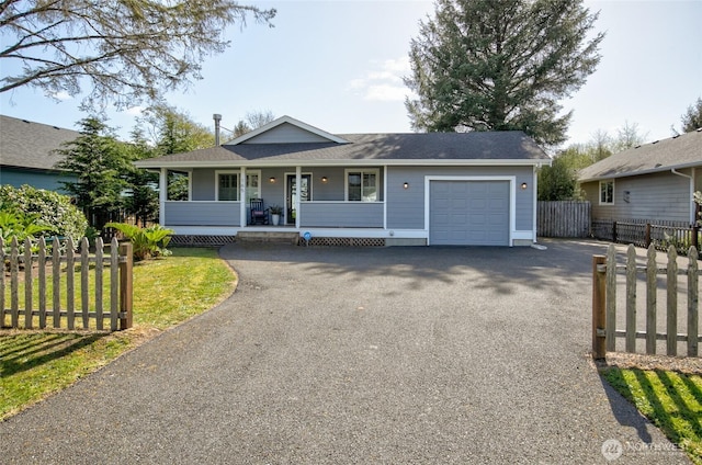single story home with covered porch, fence, a shingled roof, driveway, and an attached garage