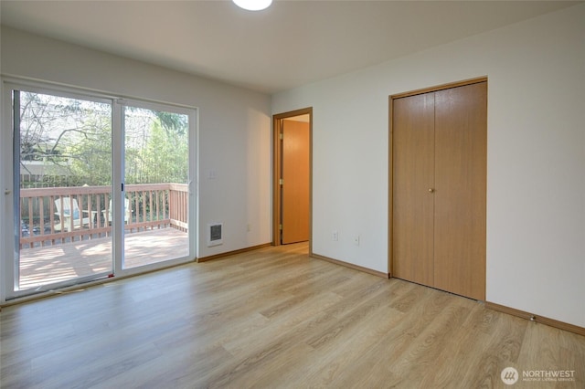 unfurnished bedroom with light wood finished floors, a closet, access to outside, visible vents, and baseboards
