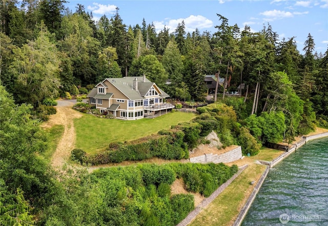 aerial view with a wooded view and a water view