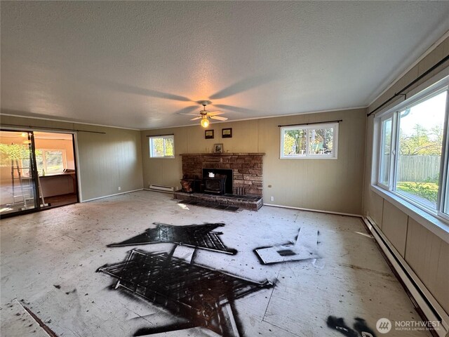 unfurnished living room featuring a baseboard radiator, a textured ceiling, and ceiling fan
